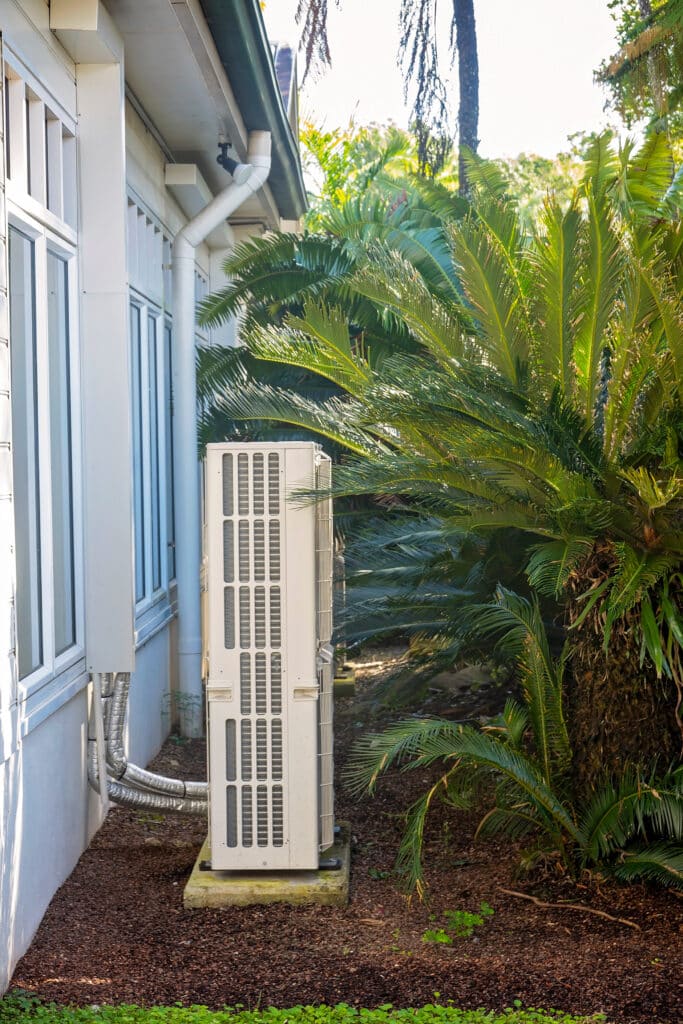 An air conditioning unit by a house